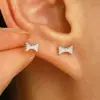 Pendientes de lazo de perlas estilo europeo y americano con personalidad y temperamento femeninos con pendientes redondos huecos de diamantes de colores y bordes cruzados.
