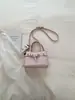 Bolso Pequeño Cuadrado de Mano Popular de Moda Estilo Coreano para Mujer Nuevo Primavera/Verano 2026 Color Sólido Simple Bolso Cruzado de un Solo Hombro Kelly