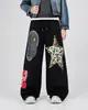 Calça de moletom com estampa camuflada de marca americana de moda de rua para homens e mulheres, estilo casual, adequada para dança de rua e dança jazz, calça esportiva de perna larga com cordão