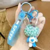 Chaveiro Copo de Chá com Leite Iceberg Colorido Transfronteiriço Pingente de Bolsa para Casal Anel de Chaveiro Exquisito com Areia Movediça Líquida