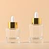 Em estoque 40ml grande círculo essência garrafa líquida cilíndrica ombro plano garrafa de óleo essencial 50ml garrafa conta-gotas de vidro de fundo grosso
