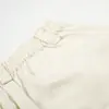 Pantalones holgados de pierna ancha para hombre con un estilo de moda urbana, que presentan diseños de cuentas y remaches metálicos, pantalones casuales únicos y ligeramente acampanados