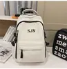Mochila de viaje versátil estilo coreano para parejas con bordado de letras, mochila escolar elegante y duradera para chicos de secundaria y preparatoria