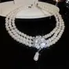 Collar de perlas con colgante de flor y gota de agua tachonado de diamantes para mujer, diseño de moda nicho, cadena versátil para la clavícula, accesorio elegante y de lujo ligero