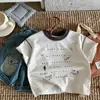 Camiseta Bora Kidsren de Algodão Puro Manga Curta Desenho Graffiti Gola Redonda Manga Meia para Meninos e Meninas Verão Nova Roupa Infantil