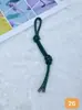 Pingente de Bolsa de Couro Colorido Criativo Moda Versátil DIY Corda de Couro Pingente de Nó Duplo Pingente de Chaveiro de Celular