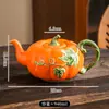 Conjunto criativo de cerâmica para café e chá em formato de abóbora, best-seller transfronteiriço, apresentando uma elegante xícara e pires em formato de folha laranja, e um bule