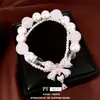 Pulsera con colgante de lazo de circonita con perlas de doble capa, sensación de lujo ligero y alta gama, accesorio de mano elegante y versátil