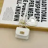Mini bolsa de presente simples pode guardar fones de ouvido e chaveiros, bolsa de fone de ouvido de cor sólida, pingente de couro, bolsa quadrada criativa, bolsa longa