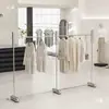 Expositor de tienda de ropa de pie de acero inoxidable isla negra barra colgante plateada estanterías para tienda de ropa de mujer expositor