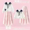Conjunto de duas peças estilo preppy para meninas para o início do outono: moletom estiloso com gola Peter Pan, laço e saia branca em camadas