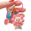 Popular Llavero de cara sonriente flor cerdo femenino lindo moda cadena exquisita cerdo muñeca de resina llavero colgante de mochila escolar