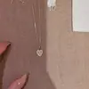Nuevo collar de corazón láser para mujer, simple y versátil, diseño de moda, lujo ligero, sensación de alta gama, cadena para la clavícula nicho y minimalista