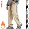 Venta al por mayor transfronteriza de Amazon de pantalones casuales holgados con cordón, bloques de color, forro polar de peso pesado para otoño e invierno para hombre