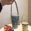 Funda para taza de té de leche portátil de dibujos animados de perro linda estilo Ins, bolsa de lona, funda aislante para taza de café anti-quemaduras al por mayor