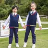 Nuevos estilos de otoño e invierno para uniformes de jardín de infantes: un conjunto de tres piezas de cortavientos, uniformes escolares primarios y ropa deportiva, en color naranja, para uniformes de clase infantil