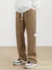 Pantalones de punto liso texturizado de pierna recta para hombre, europeos y americanos, de estilo cruzado, holgados y cómodos con cintura de cordón, estilo básico para ir al trabajo y uso casual