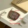 Bolsita pequeña de tela rayada étnica colorida transfronteriza con ribete de imitación de cuero, llavero portátil, bolsa de almacenamiento para auriculares, monedas y tarjetas