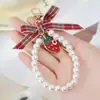 Fabricantes transfronterizos de gran venta en nombre de pulsera de cinta de rayas de hojas perla fresca pequeña llavero cordón para teléfono móvil joyería