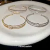 Brazalete abierto de doble capa con lazo de circón, temperamento exquisito francés, brazalete Joker, joyería de lujo ligero de alta gama, venta al por mayor