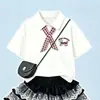 2026 Nuevo Conjunto de Dos Piezas para Niñas de Verano Estilo Preppy Camisa Polo de Manga Corta con Borde de Encaje Dulce Falda de Capas