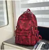 Mochila retro tie-dye con estampado de estrellas rojas y negras, estilo workwear unisex, elegante y genial para adolescentes y estudiantes.