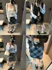 Además, la nueva minifalda de lana de estilo retro coreano para otoño, de cuadros, de cintura alta, entalladora y línea A, MQ1682