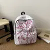 Fábrica de origen de comercio exterior estilo coreano graffiti nailon gran capacidad casual deportivo moderno mochila para estudiantes de secundaria
