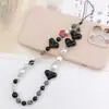 Nueva cadena de cuentas para teléfono móvil blanco y negro amor cordón para teléfono móvil colgante para teléfono móvil cuentas rayadas amor anti-pérdida tendencia portátil