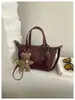 Bolso de hombro individual de temperamento simple para ir al trabajo Bolso de mano versátil de nuevo estilo transfronterizo Bolso tipo cubo Bolso cruzado casual retro Maillard
