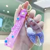 Llavero creativo de cangrejo de arena con pinza, criatura marina con dinero en la mano, lindo colgante para bolso, llavero de coche de dibujos animados
