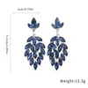 Pendientes de botón con diseño de hoja ovalada incrustada de diamantes de aguja de plata europea y americana, pendientes de diseño moderno, adornos para las orejas de lujo ligero de alta gama para mujer