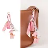 Bolsa de jirafa de moda de alta gama, estilo nuevo, versátil, linda, colgante, borla de bufanda de seda, accesorio de regalo pequeño, transfronterizo
