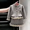 Estilo Coreano Meninas Outono/Inverno 2026 Novo Conjunto de Tricô Estilo Pequeno Chanel Suéter Cinza com Laço Saia
