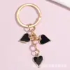 Llavero con dijes para bolso de dados con forma de corazón y goteo de aceite, el más vendido de Amazon, moderno, directo del fabricante