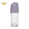 Fábrica en stock al por mayor nuevo frasco de bola rodante 50ml frasco de bola para caminar loción corporal antitranspirante frasco de vidrio tapa de granos de masaje
