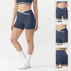 Pantalones de yoga de cintura en V europeos y americanos, shorts deportivos cortos de secado rápido para mujer con efecto melocotón en los glúteos, shorts de fitness de cintura alta para levantar glúteos para el verano