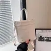 La popular bolsa tipo cubo de este año 2025 nuevo estilo coreano de nailon casual versátil de un solo hombro bandolera bolsa de mano elegante
