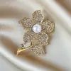 Broche de estilo antiguo nuevo de alta gama ins para mujer estilo chino abanico borla pin de traje cheongsam tapeta de presión corsage al por mayor