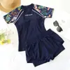 Nuevo traje de baño de mujer estilo tankini 2026, adelgazante y que esconde la barriga, de manga corta, adecuado para aguas termales, playa y vacaciones en resorts, conjunto de dos piezas
