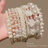 Tiara de Pérolas Artificiais de Luxo para Mulheres 2026 Novo Estilo Aro de Cabelo Versátil para Sair Clipe de Cabelo Alto para o Verão Acessórios de Cabelo