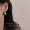 Pendientes vintage redondos transparentes, sencillos y distintivos para mujer, diseño de nicho de lujo ligero, elegantes y combinables de alta gama.