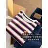 Camiseta de punto de manga corta de alta gama y alta resistencia con bloques de color, rayas y logo bordado para mujer, nuevo modelo de primavera de Zedaijiayi