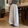 Pantalones anchos de pierna ancha, corte holgado, estilo coreano de alta costura para mujer, colección otoño 2026, con cintura de cordón, bolsillos grandes y un diseño relajado hasta el suelo.