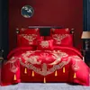 Algodón de fibra larga de Xinjiang dragón y fénix rojo juego de cuatro piezas rojo ropa de cama de algodón rojo boda algodón funda de edredón amigable con la piel sábana de cama
