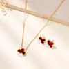 Set de collar y aretes de acero inoxidable de moda de lujo ligero con trébol de cuatro hojas, popular en Europa y América, exclusivamente para ventas transfronterizas