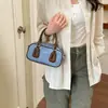 Bolso de hombro de nuevo diseño 2026, bolso baguette cruzado de moda, versátil para el trabajo, bolso niche azul tipo bowling para mujer