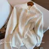 Cárdigan de punto jacquard calado estilo francés blanco para mujer, nueva colección de otoño, de alta gama, simple, elegante y suave, abrigo suéter