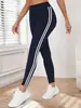 Pantalones de yoga de estilo europeo y americano con rayas laterales de cintura alta para mujer, leggings deportivos finos de primavera/verano para correr, adecuados para uso en exteriores, leggings ajustados de nueve puntos.