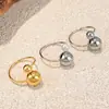 Anillo Transfronterizo Europeo y Americano de Acero de Titanio Oro 18K Doble Bola Anillo Abierto Dorado Diseño de Nicho Joyería de Acero Inoxidable Perla